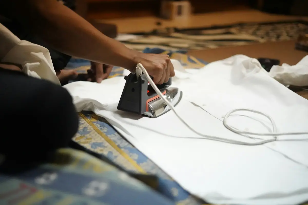 A shirt being pressed on a finishing table