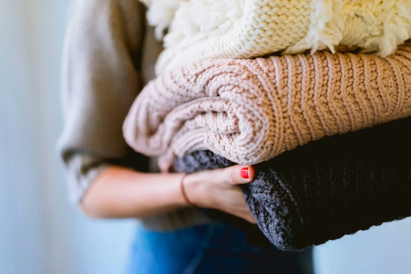 Folded knitwear held in both hands